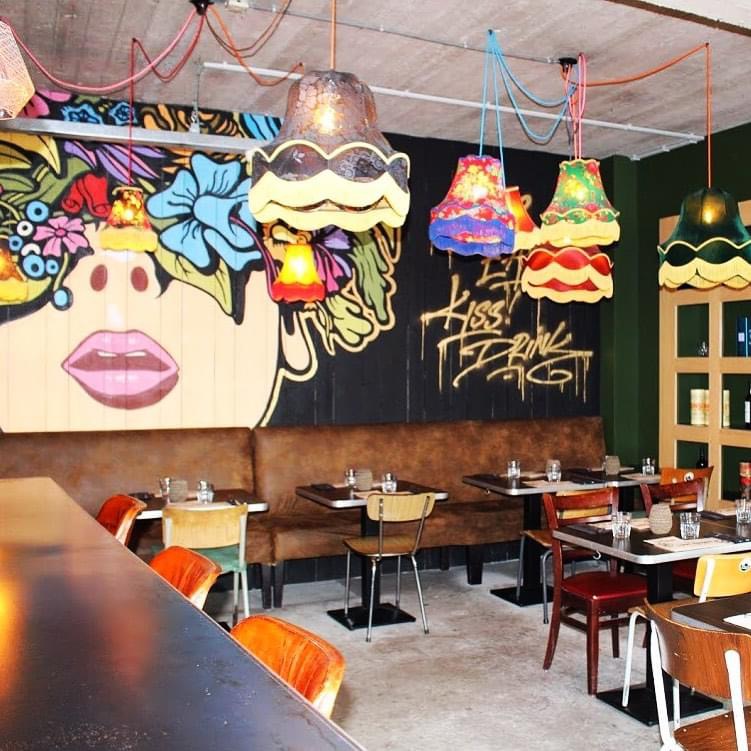 Fresque murale colorée et abat-jour vintage dans la salle d'I Love Burger